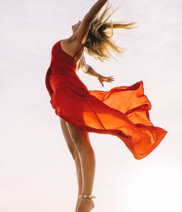 Woman feeling vibrant and energetic in a bright, open space.